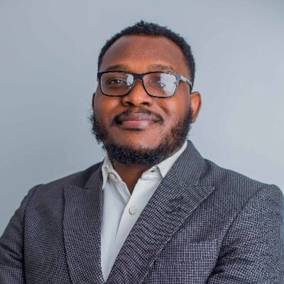 Portrait of a man wearing glasses and a suit jacket - International Awards