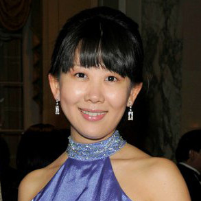 Smiling woman in a purple halter dress at a formal event. - International Awards