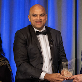 Ramchandra R Mallya accepting an award at an event. - International Awards