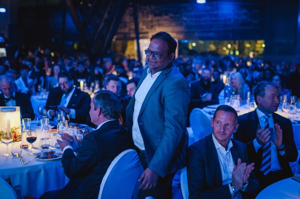Business professionals networking at a formal awards ceremony, celebrating achievements. - International Awards