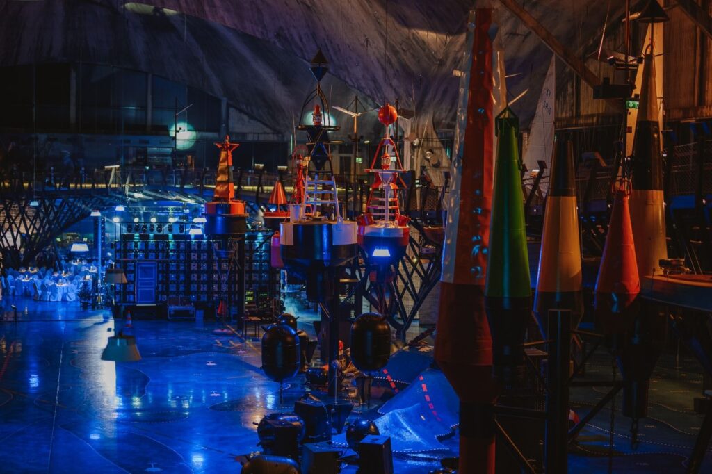 Interior view of a maritime museum, showcasing various navigation buoys and lights. - International Awards